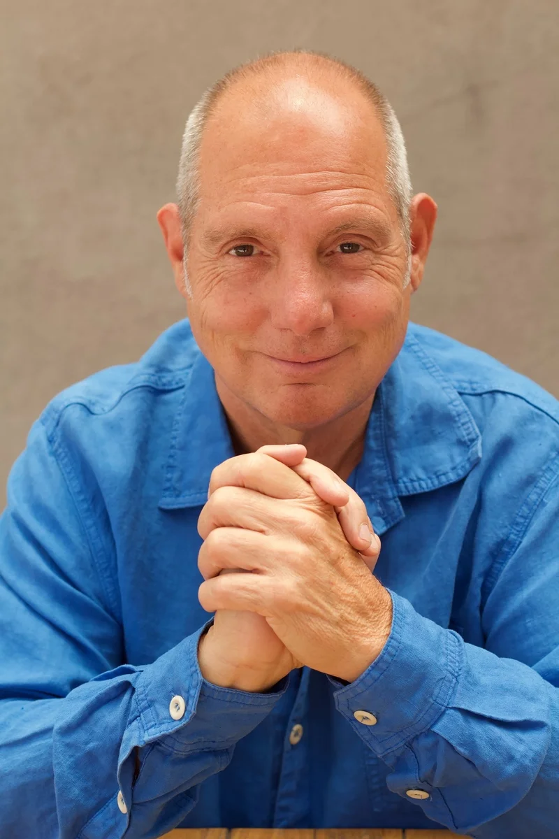 Robert Colt, present day — leaning forward, listening